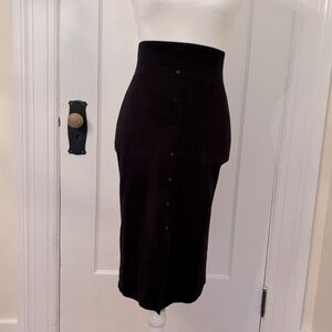 Black straight skirt with decorative buttons down the front.